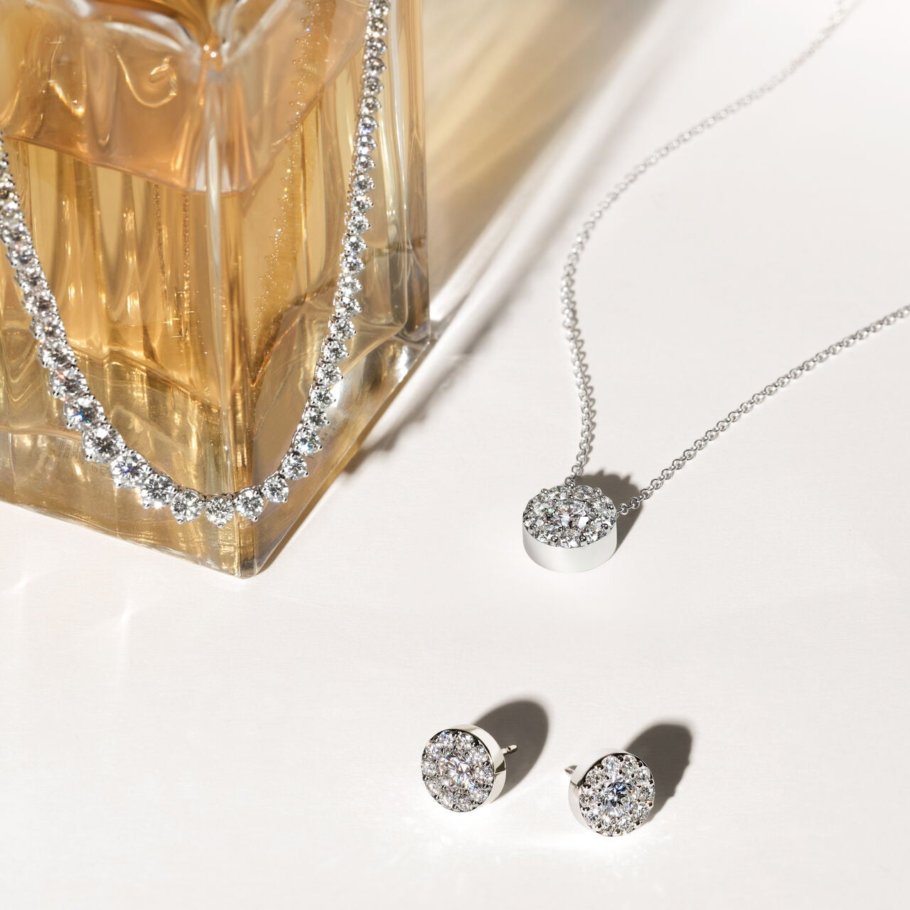 Hearts On Fire Jewelry Lifestyle Image: Perfume Diamond Necklaces and Diamond Earrings 